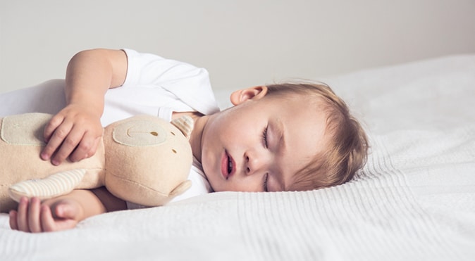 Child sleeping with Teddy Bear, Better Sleep Council