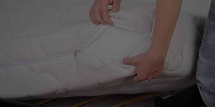 Hands holding end of unzipped mattress, Better Sleep Council