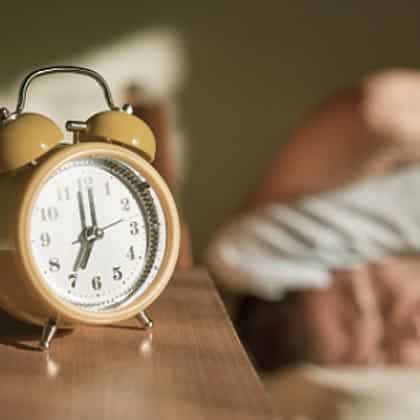Yellow alarm clock on bedside table, Better Sleep Council