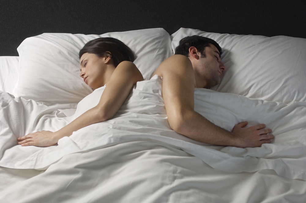 Couple sleeping in bed back to back, Better Sleep Council